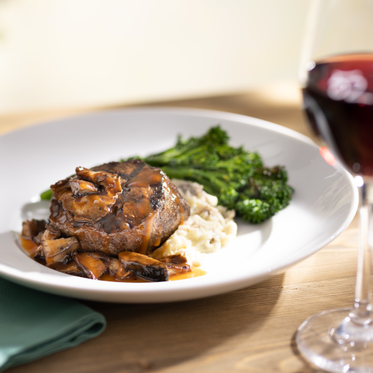 Wood-Grilled Filet Mignon served with broccolini, Yukon mash, red wine and mushroom sauce. by Seasons 52