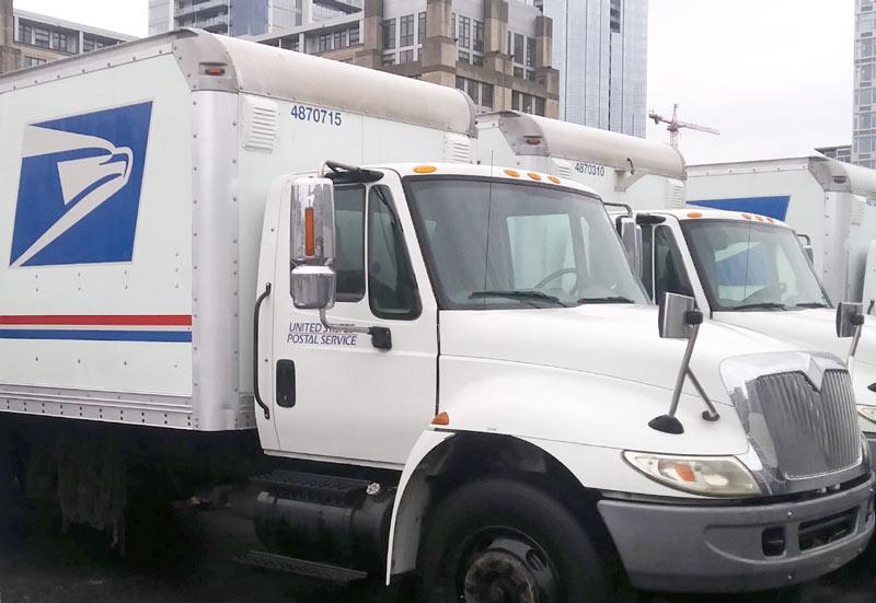 Snugs Services technician providing professional fleet washing for a commercial fuel delivery truck using specialized pressure washing equipment. by Snugs Services