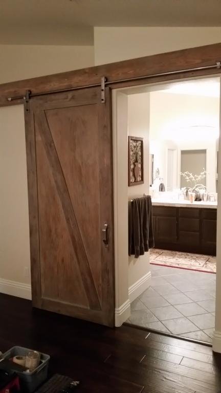 Sam Clemente Rustic and weathered door with a beam      open by AMERICAN SLIDING DOOR AND WINDOW