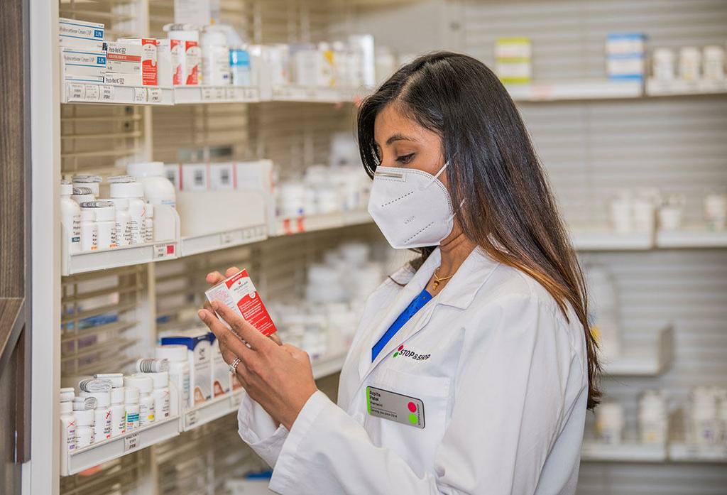 Pharmacist with mask selecting medications by Stop & Shop
