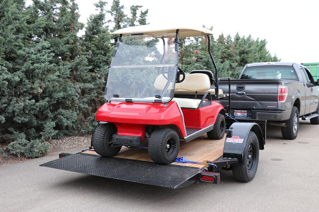 Tilt Trailer Hauling Golf Cart by TrailersPlus