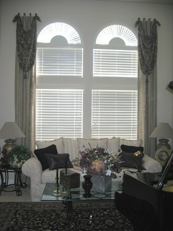 Dramatic Single Swags over Panels with Wood Blinds and Arches by Visions Decorating Incorporated
