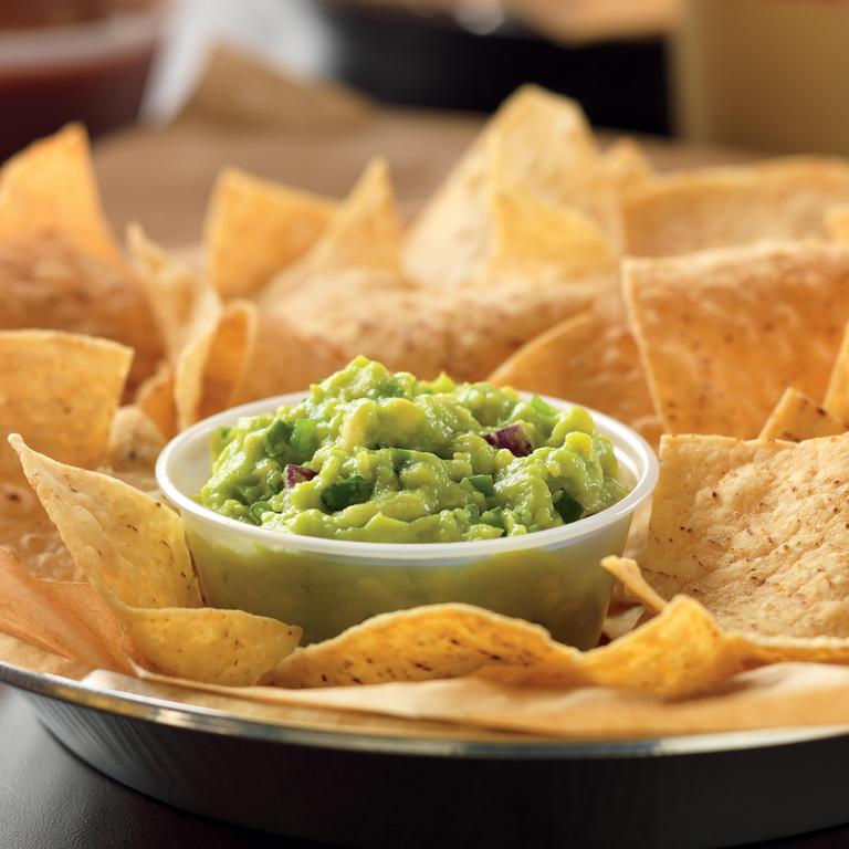Hand-smashed-in-house-daily guacamole is best served with freshly fried in-house tortilla chips. by QDOBA Mexican Eats