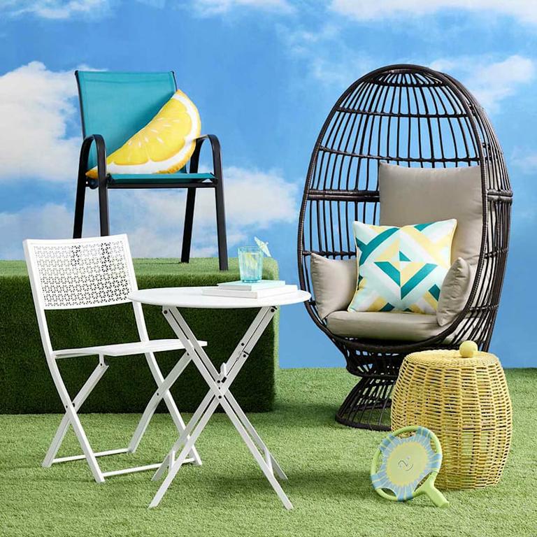 A stackable teal sling patio chair, perfect for outdoor lounging or dining with its comfortable design and vibrant color. by At Home