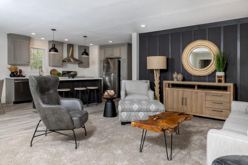 This modern manufactured home features accent wall in the living room, overlooking the kitchen. by Oakwood Homes
