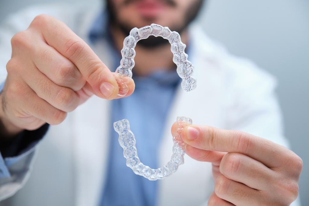 unrecognizable-orthodontist-holding-trainer-dental-2023-11-27-05-27-59-utc (1) by Distinctive Dentistry