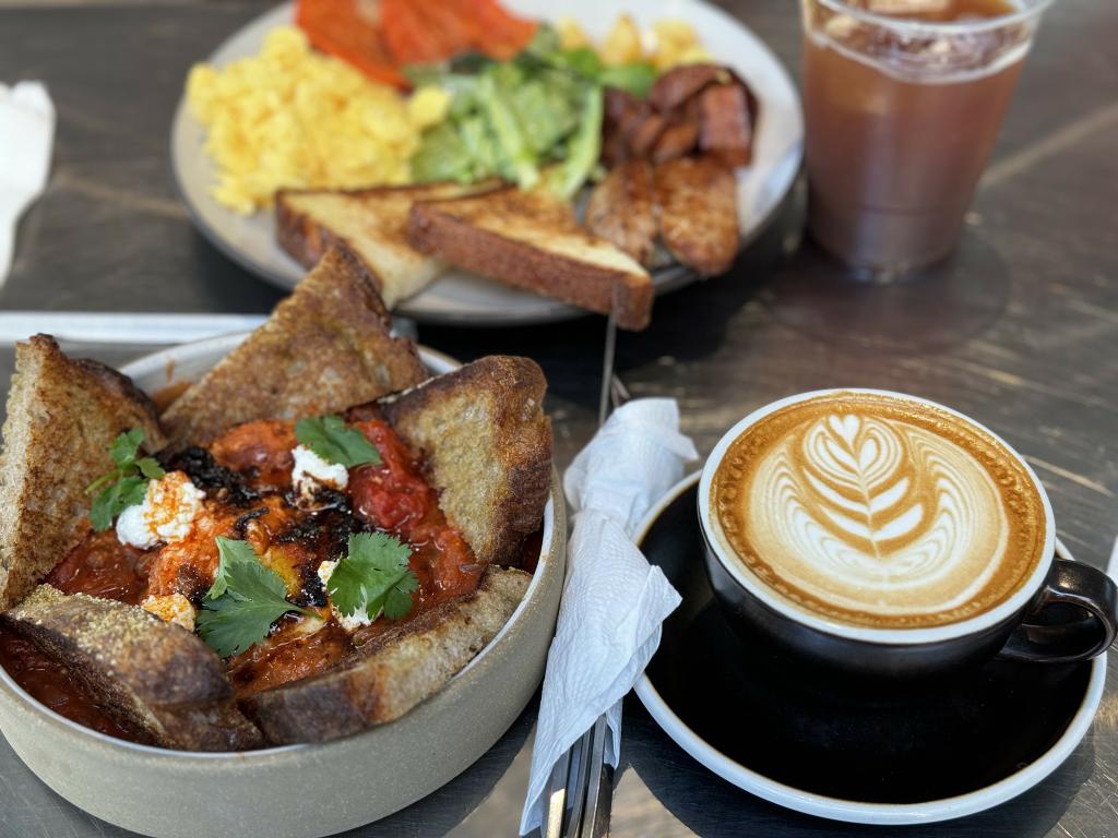 A signature White Noise Coffee fusion dish, our Spicy Shakshukjang features perfectly poached eggs, creamy ricotta, and fresh cilantro, served at our Downtown Brooklyn cafe. by White Noise Coffee - Coffee Shop & Roastery