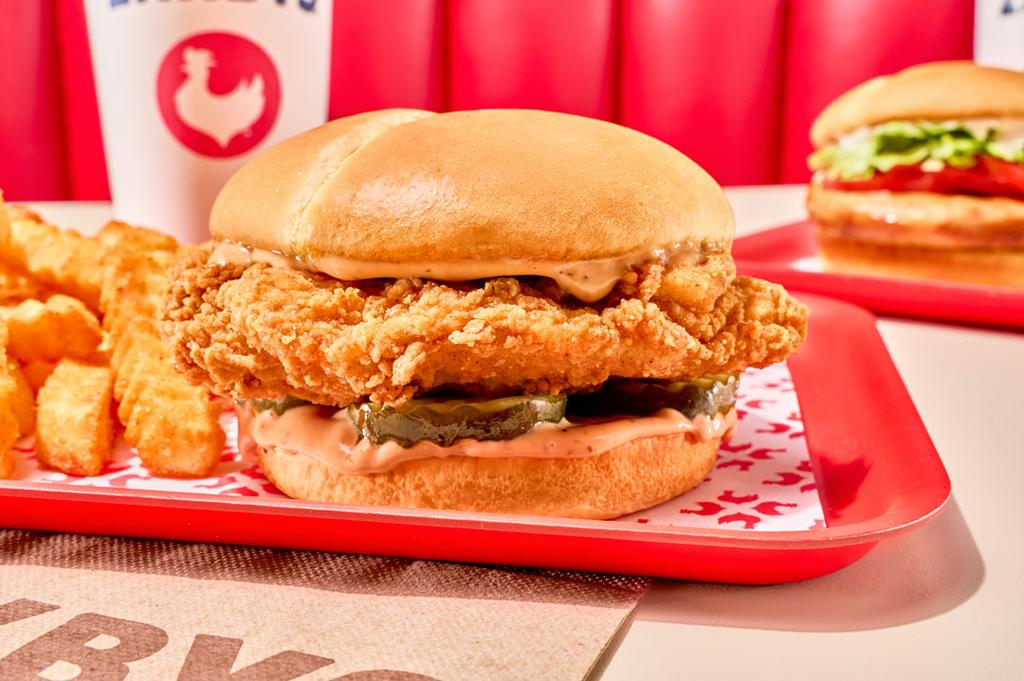 Close-up of Zaxbys Signature Chicken Sandwich served with crinkle fries and Zax Sauce. by Zaxbys Chicken Fingers & Buffalo Wings