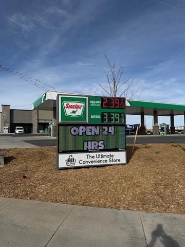 Sinclair gas station fueling island. by Sinclair Gas Station