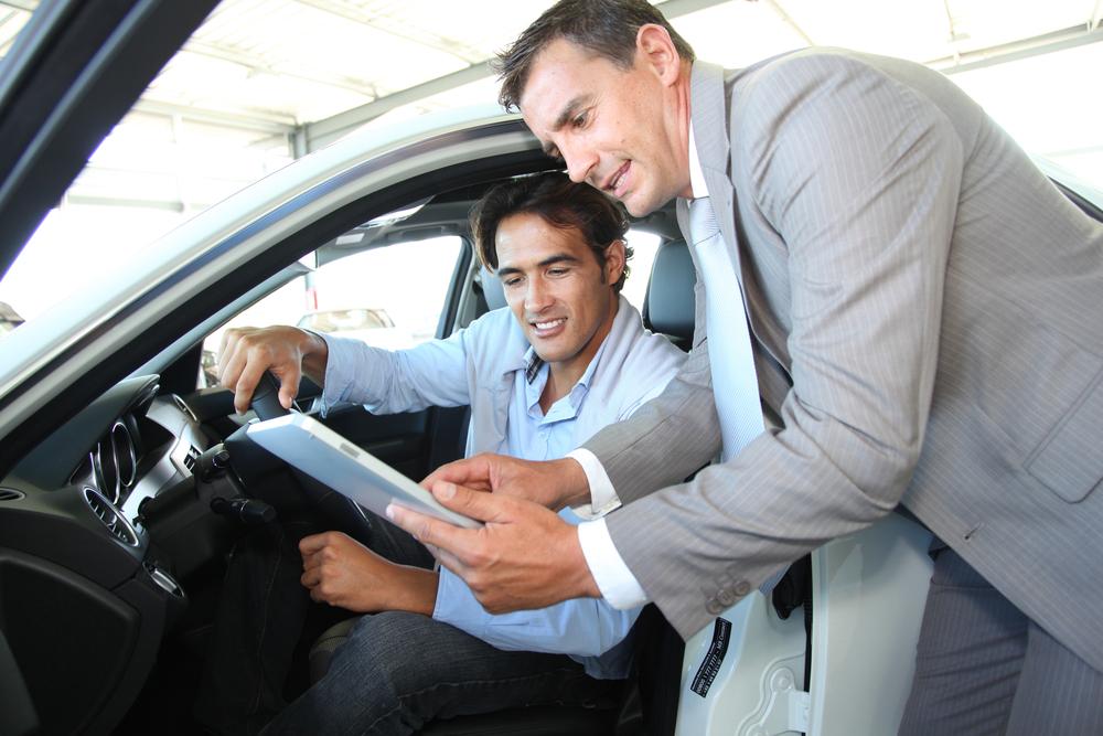 Car seller with car buyer 