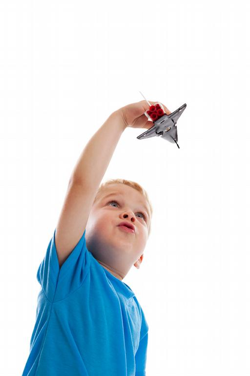 boy plays with shuttle model