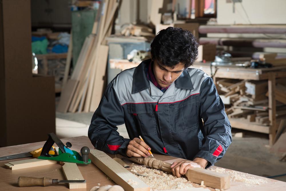 carpenter makes an angled cut,